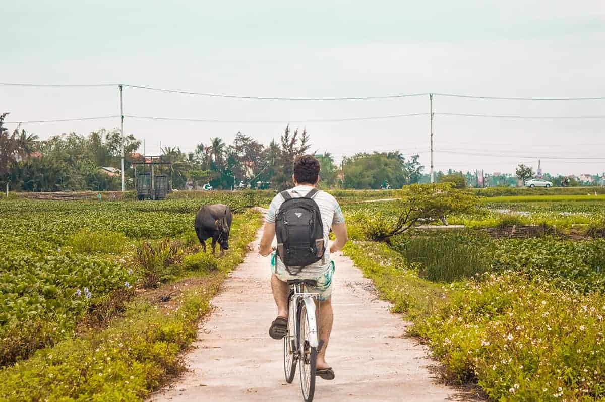 biking through the fields in the hoi an itinerary