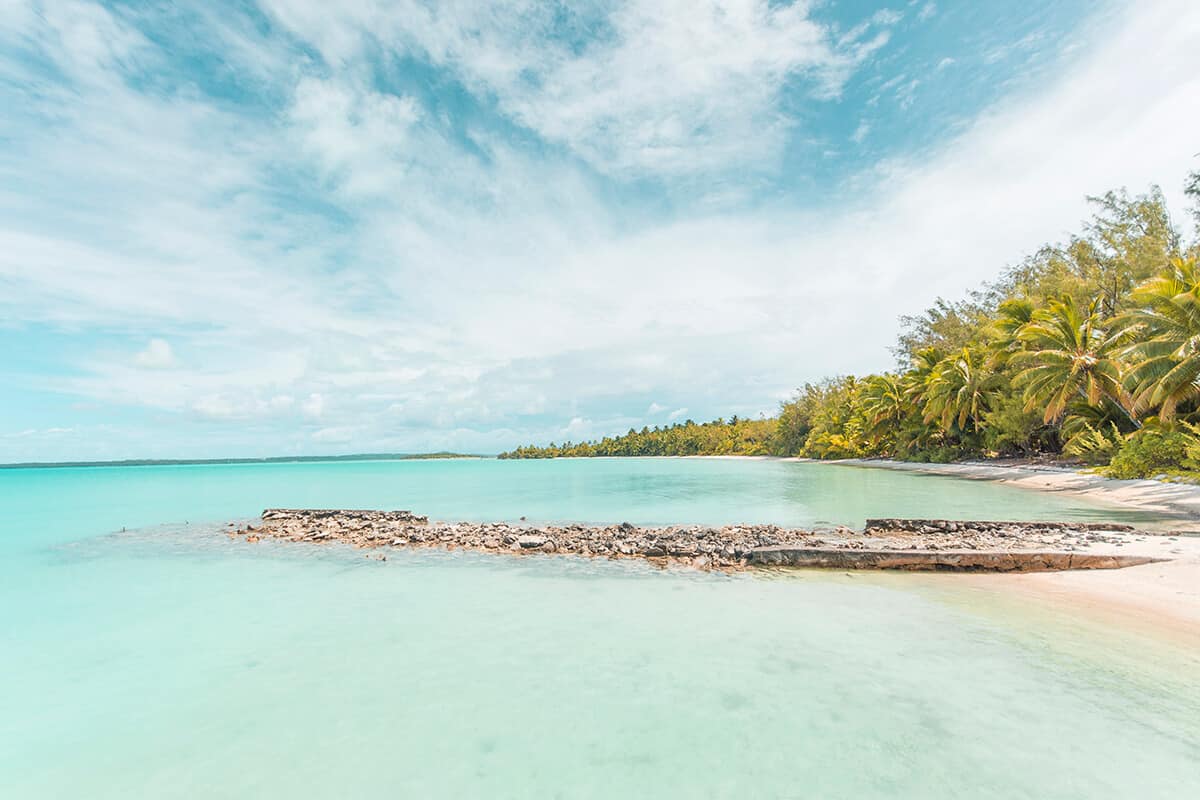 an old wharf sitting just above the waterline in aitutaki