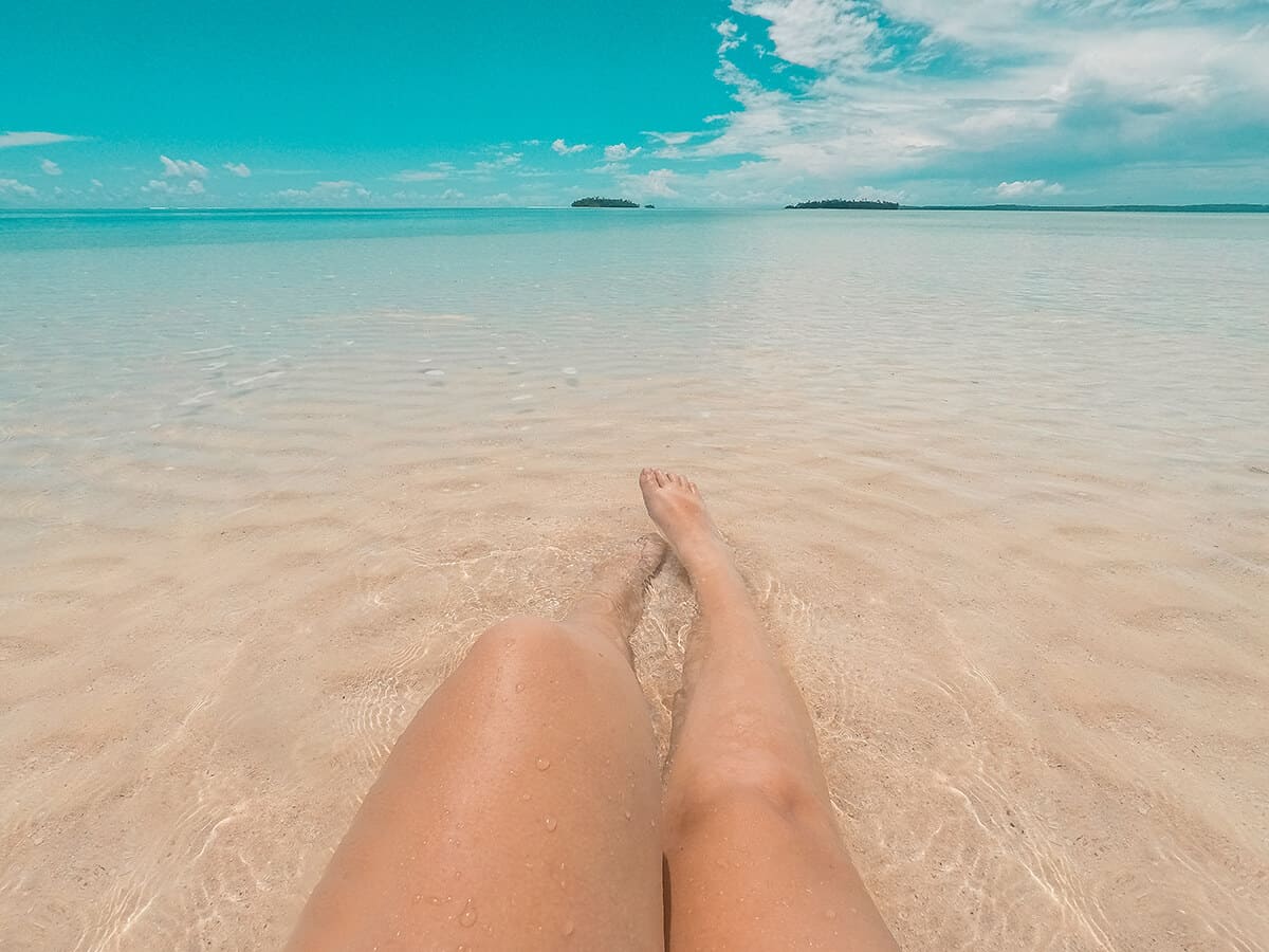 enjoying the shallow waters sitting on a sand bar in aitutaki