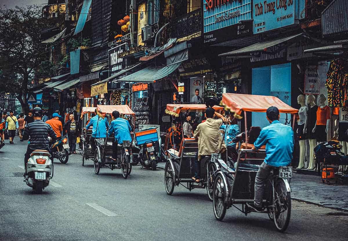 busy streets of hanoi filled with cycle rickshaws and motorbikes