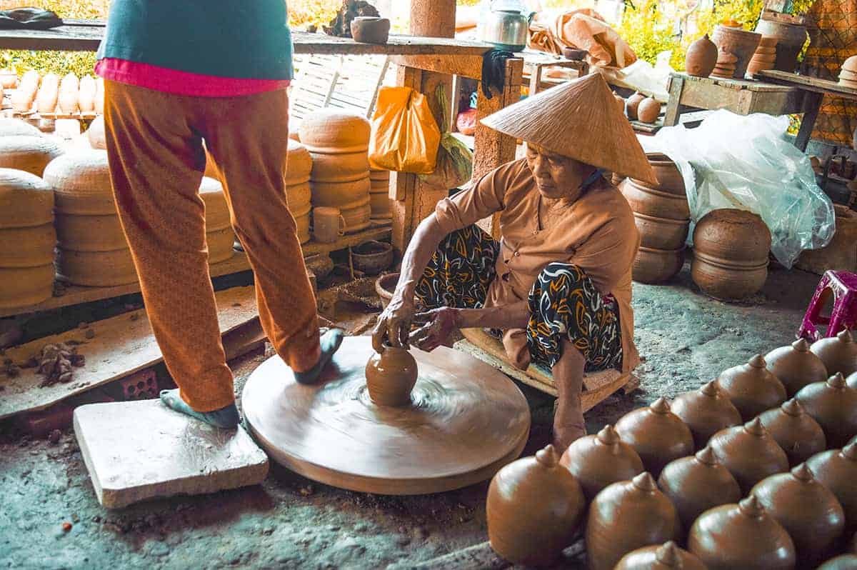spinning clay at the pottery village on the hoi an itinerary
