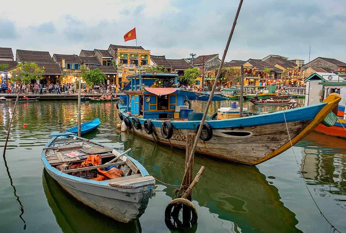 boats lined up on the river while backpacking hoi an ancient town