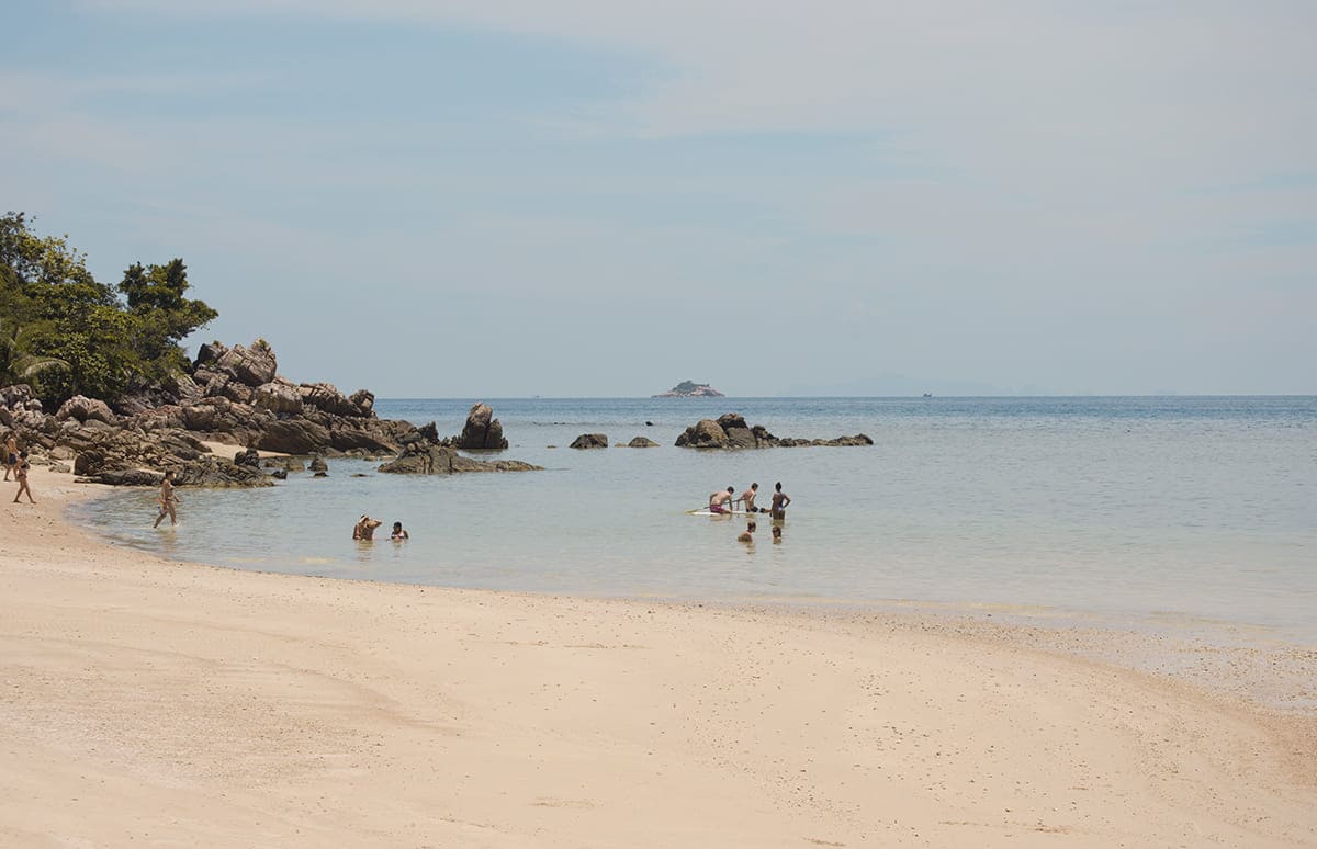 backpackers swimming at one of the beaches in koh phangan