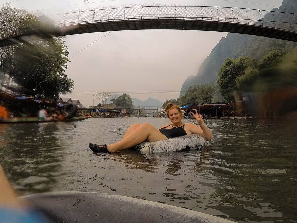 tubing in vang vieng under bridge