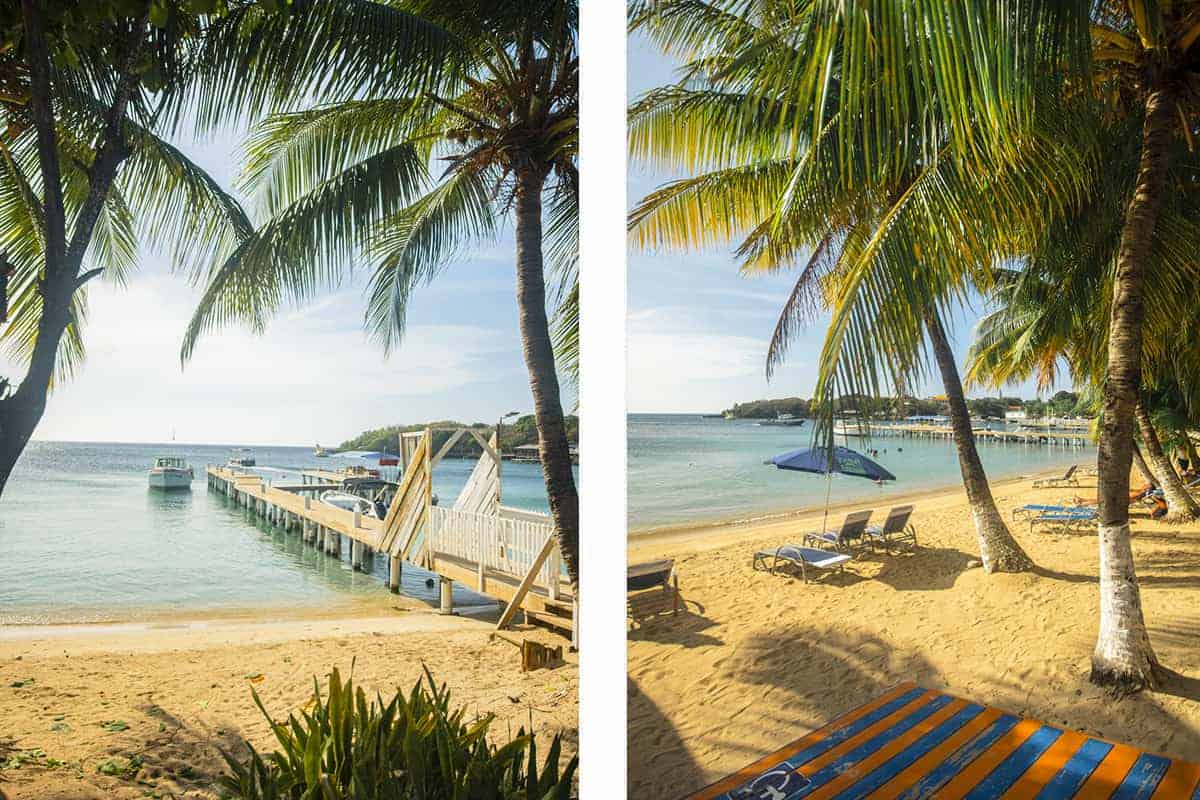 golden shores with a couple of beach chairs lined up on half moon bay beach in roatan