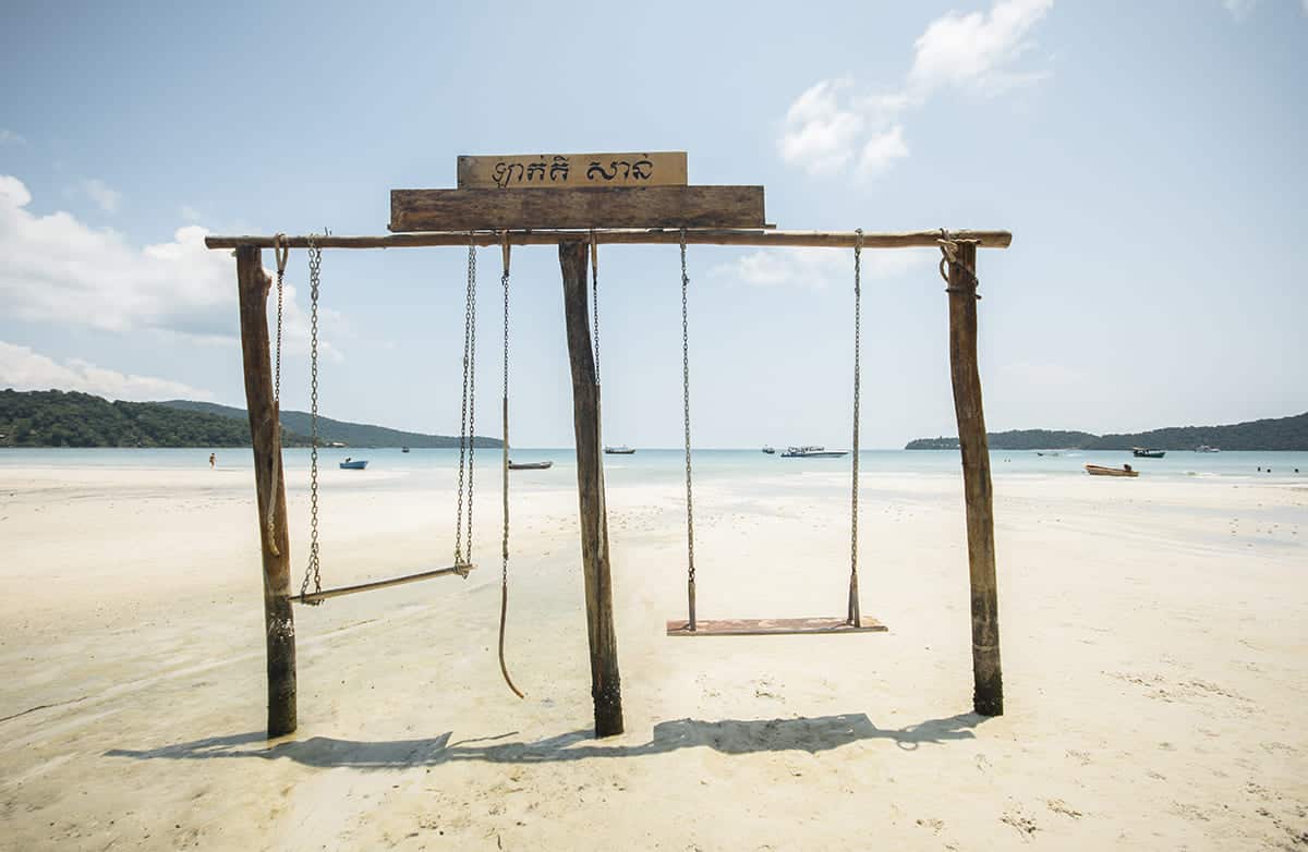 swings on the sand of saracen bay during low tide