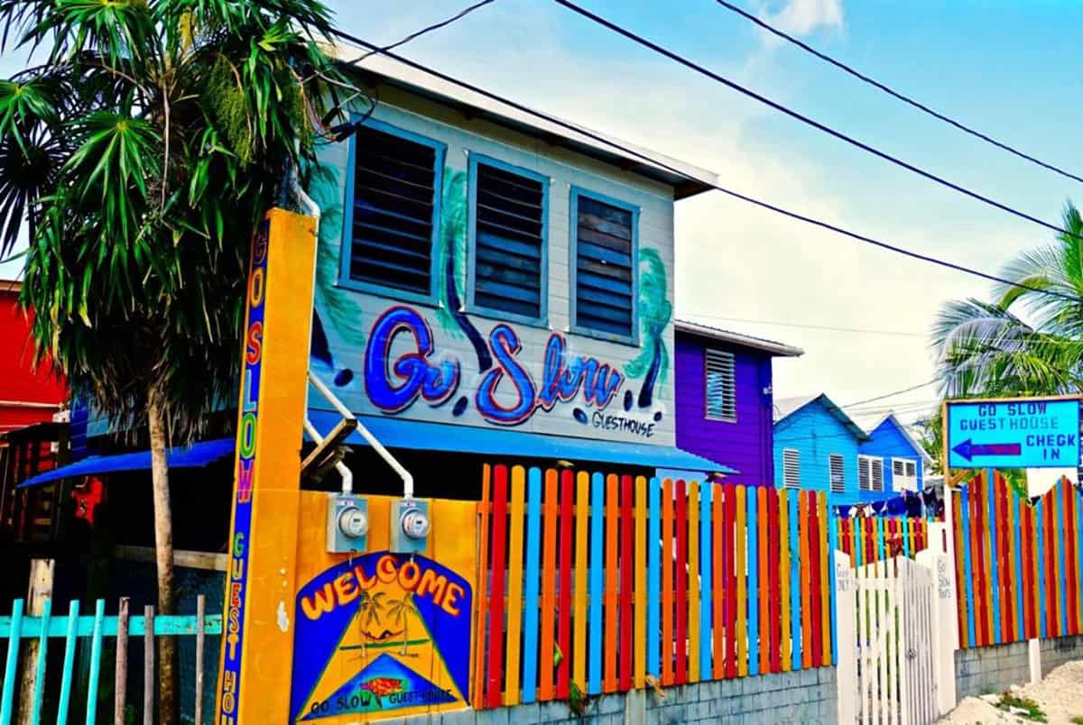 the colorful building of go slow hostel, one of the best hostels in caye caulker