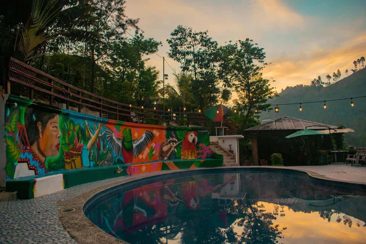 Best Hostels In Semuc Champey: For Solo Travelers, Females, Couples & More 18 beautiful and colorful mural around the pool at vinas hotel