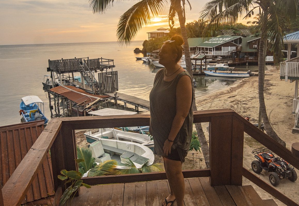 watching sunset from a balcony and doing some of the best things to do in roatan