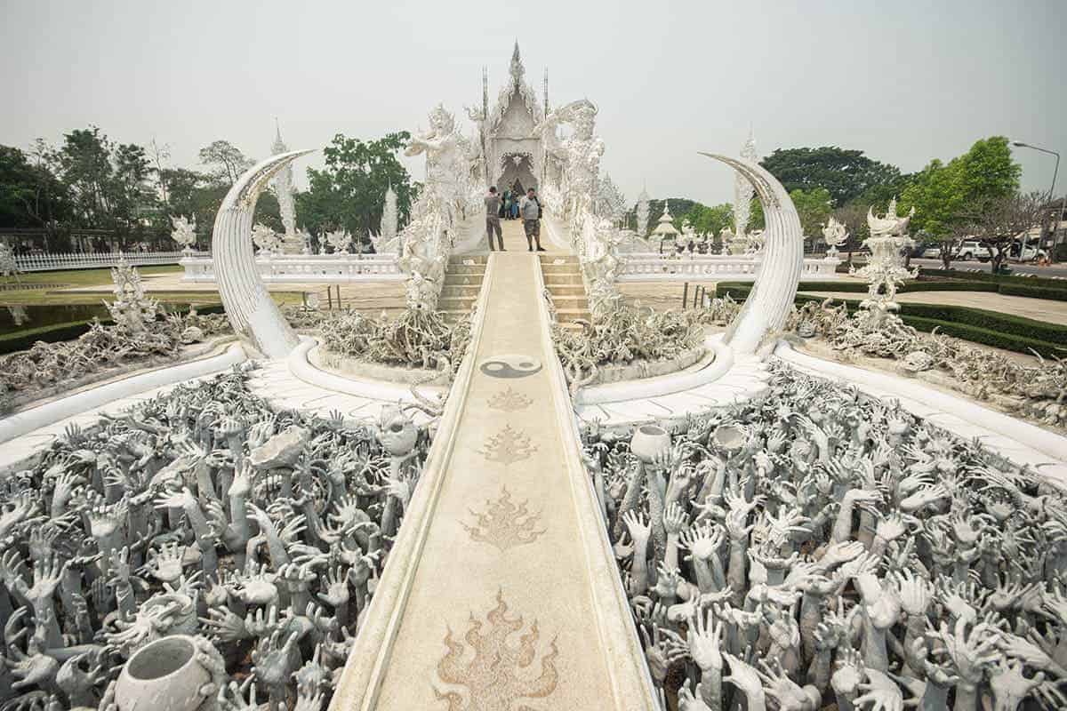 3 Days In Chiang Mai Itinerary: ULTIMATE GUIDE 2025 14 the hands reaching up at the entry to the white temple in chiang rai