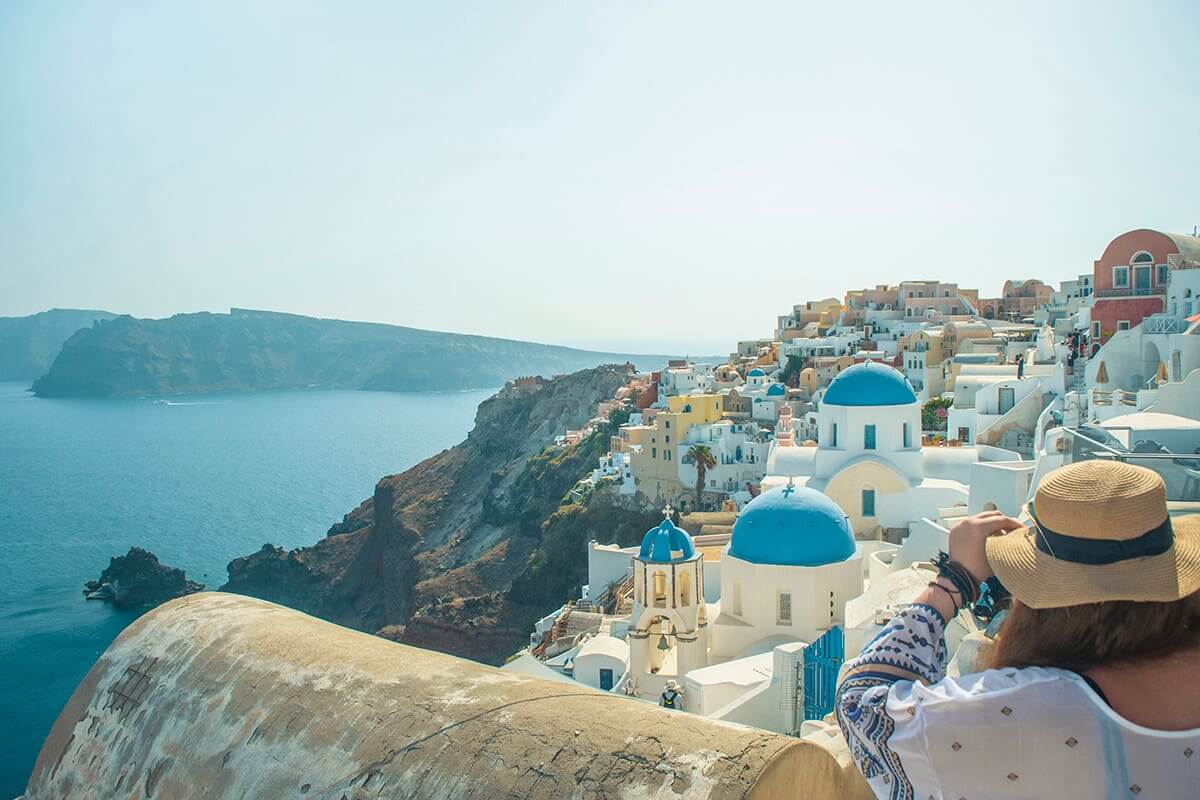 watching the clifftop views in santorini cost to travel greece