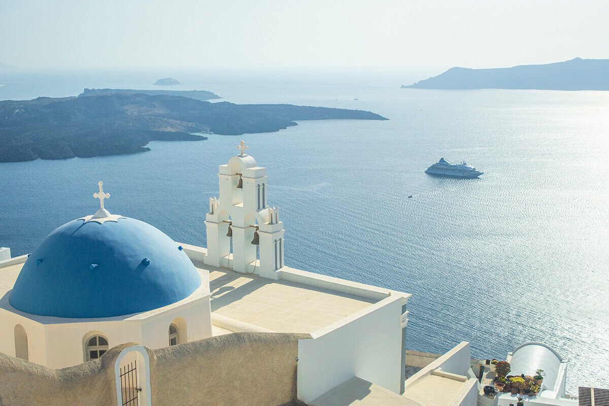 view over church to cruiseship sightseeing santorini