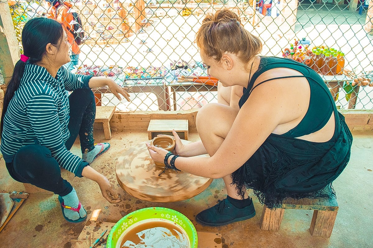 girl spinning pottery in thanh ha pottery village hoi an