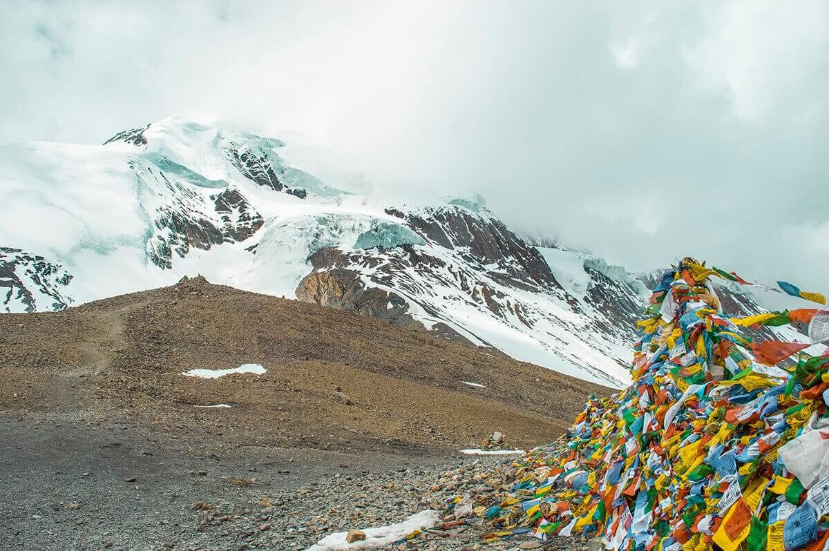 prayer flags and peaks high camp to muktinath over thorong la pass on the annapurna circuit