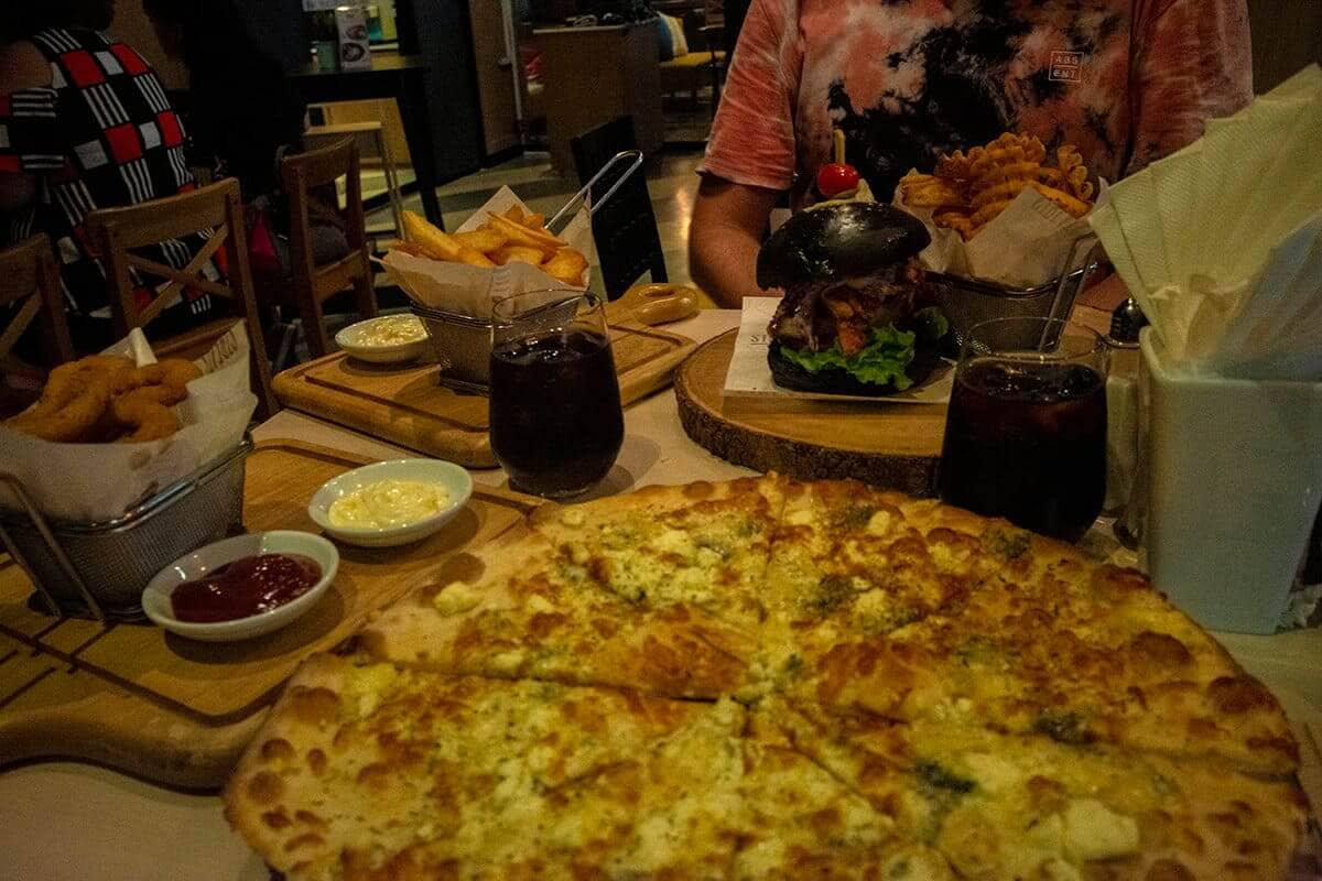 dinner for kings at streat restaurant including onion rings, chips, pizza and chicken burger
