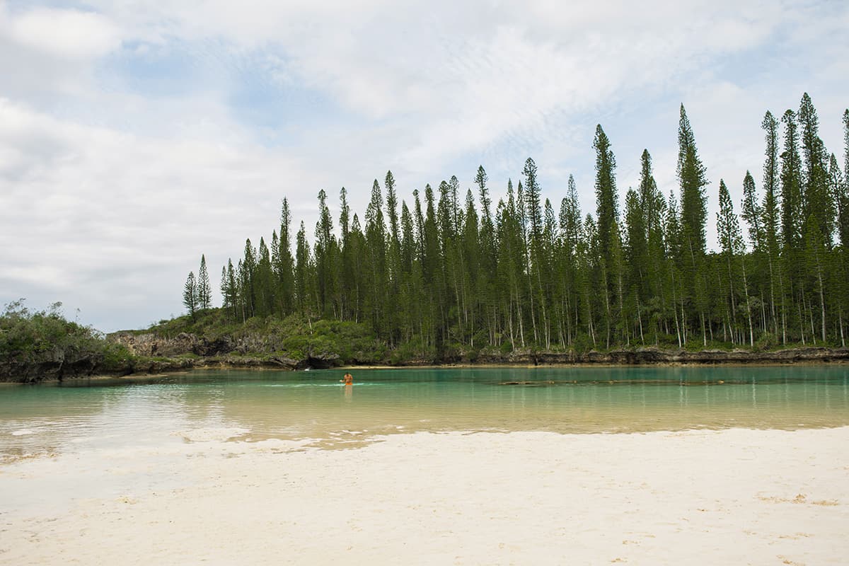 the small rocky coral sections of reef are visible through the crystal clear water