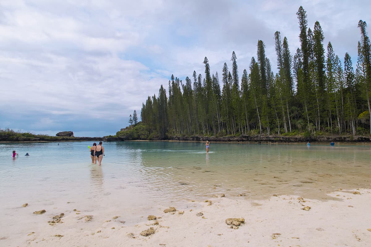 tourists hanging out and going for a snorkel at the natural pool in the isle of pines