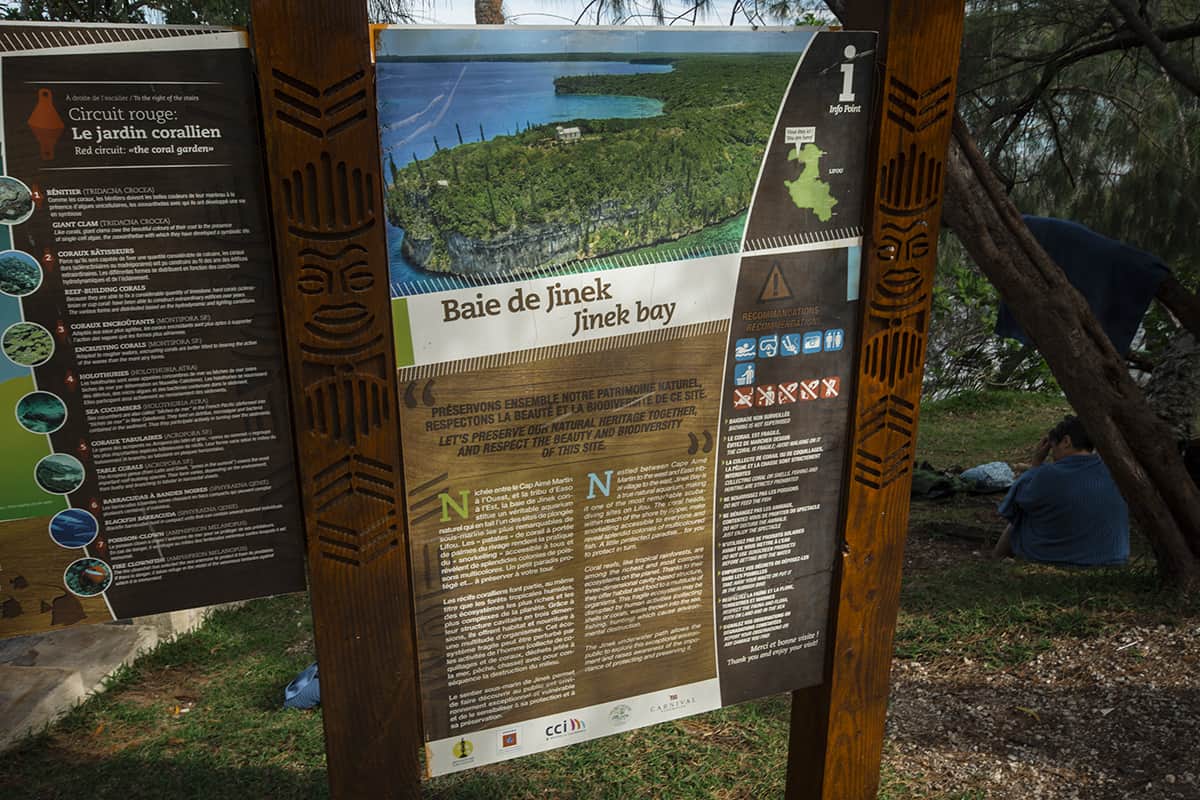an information board showcasing jinek bay in lifou