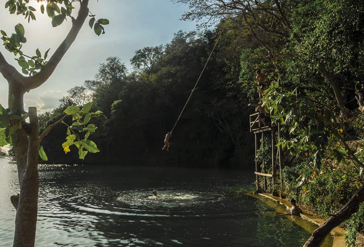jumping into the cool water from jorges rope swing in flores