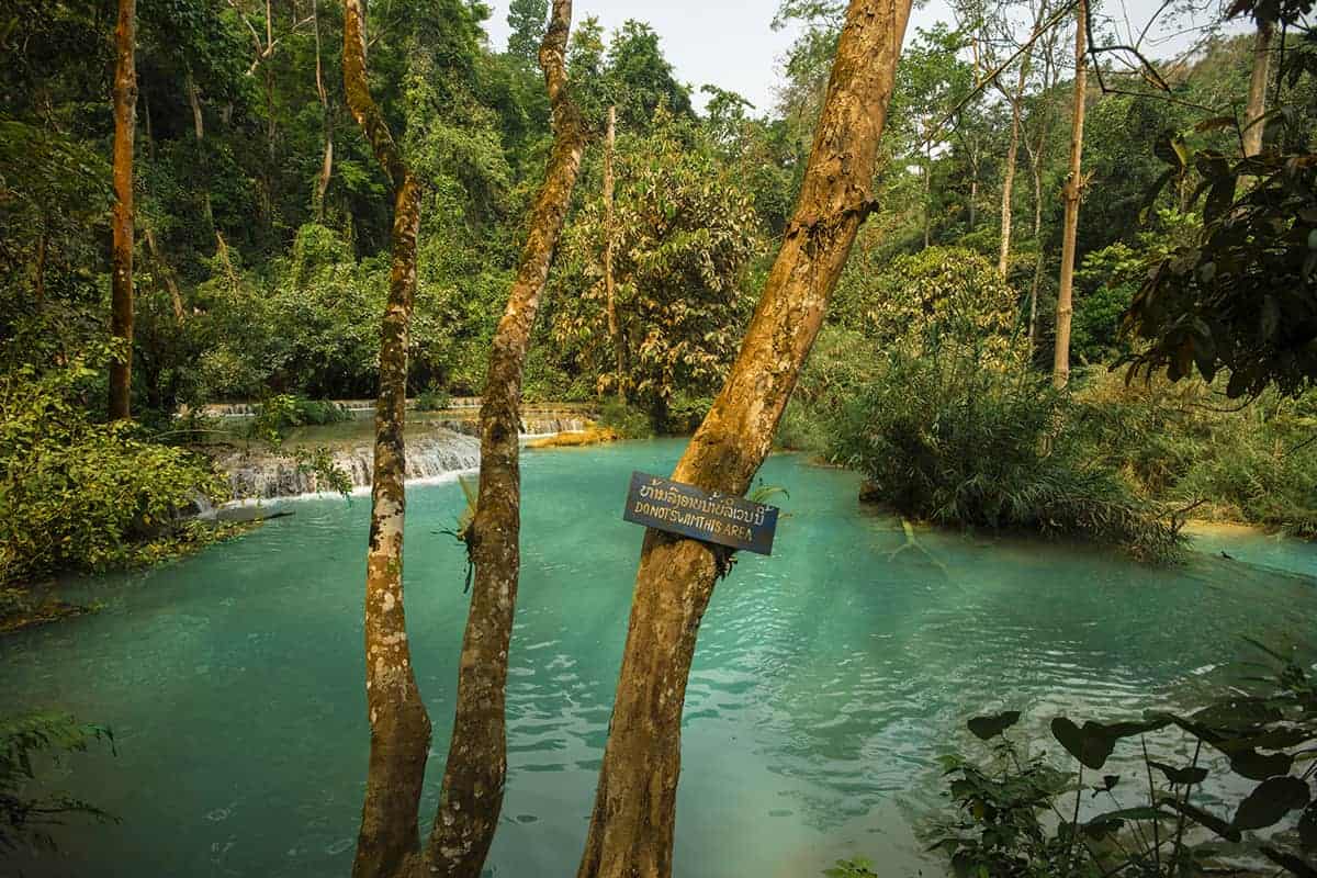 sign saying do not swim at kuang si falls