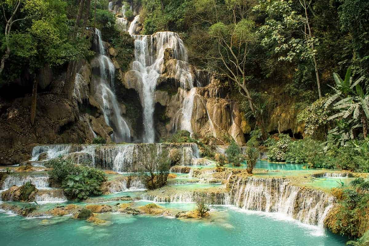 the view of the main waterfall at kuang si falls from the footbridge