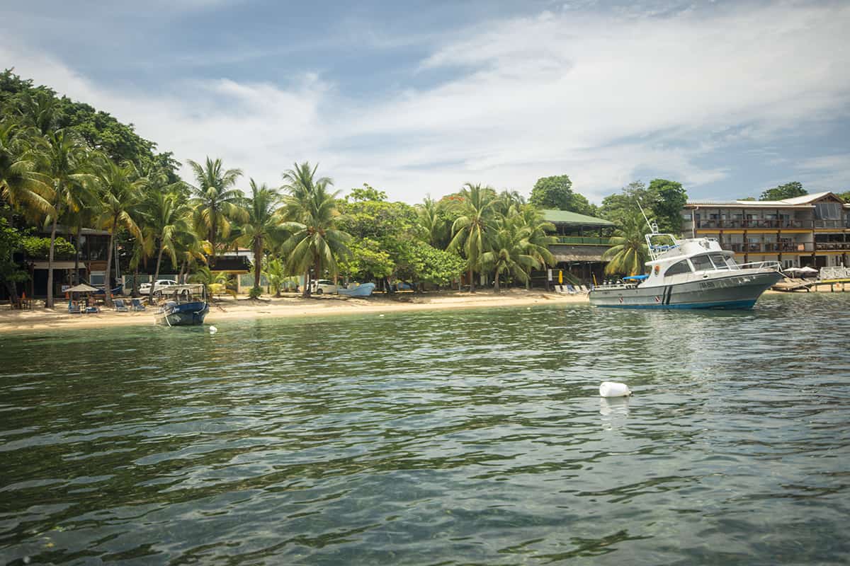 the beach at the quieter end of half moon bay in roatan