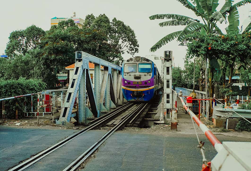 waiting on the train to pass by the crossing from mui ne to ho chi minh city