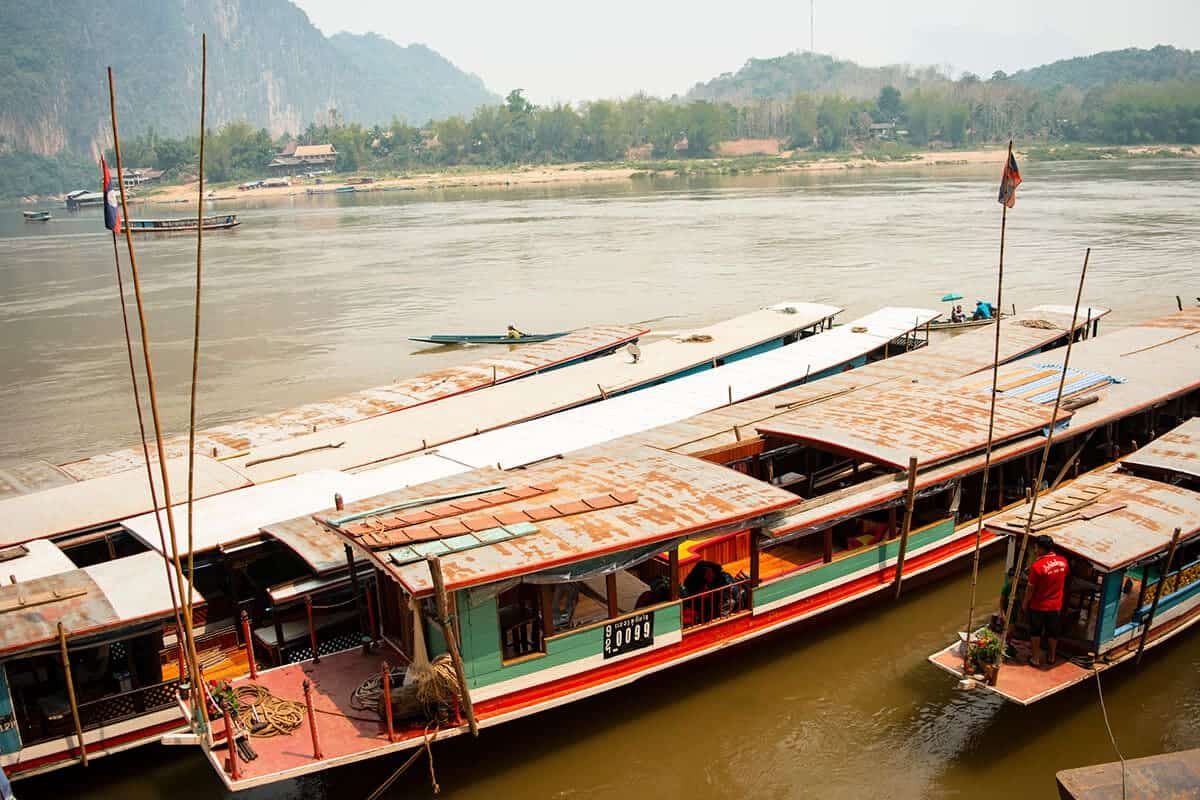 boats parked at the pier along the mekong river