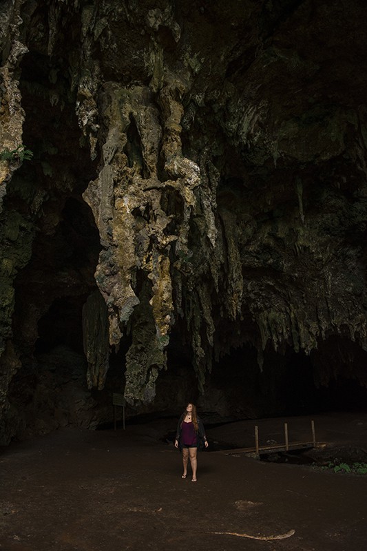 Queen Hortense's Cave In The Isle Of Pines: BEST Tips 2025 18 A woman standing in front of Queen Hortense’s Cave on the Isle Of Pines.