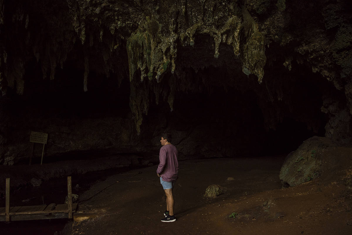 Queen Hortense's Cave In The Isle Of Pines: BEST Tips 2025 16 A man standing in front of Queen Hortense’s Cave on the Isle Of Pines.
