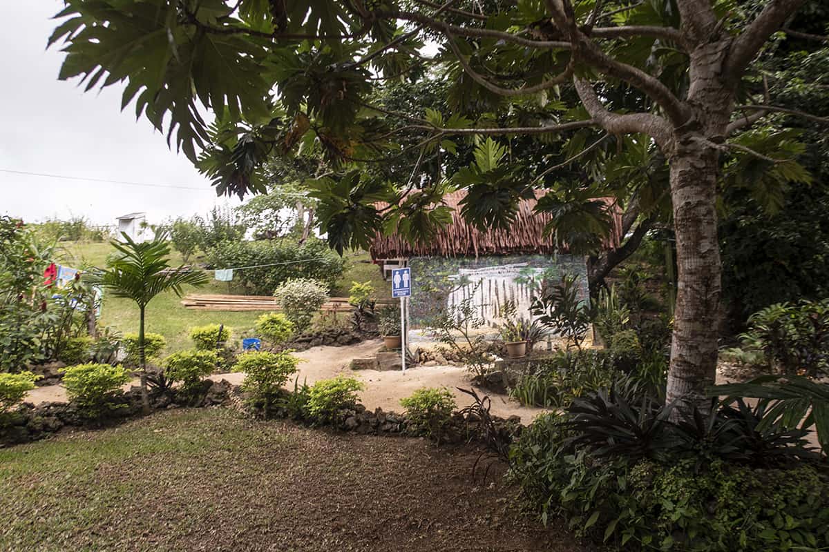 a small building with a hatched roof where you can find the changing rooms at rarru cascades