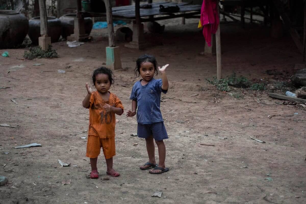 local girls waving in battambang cambodia
