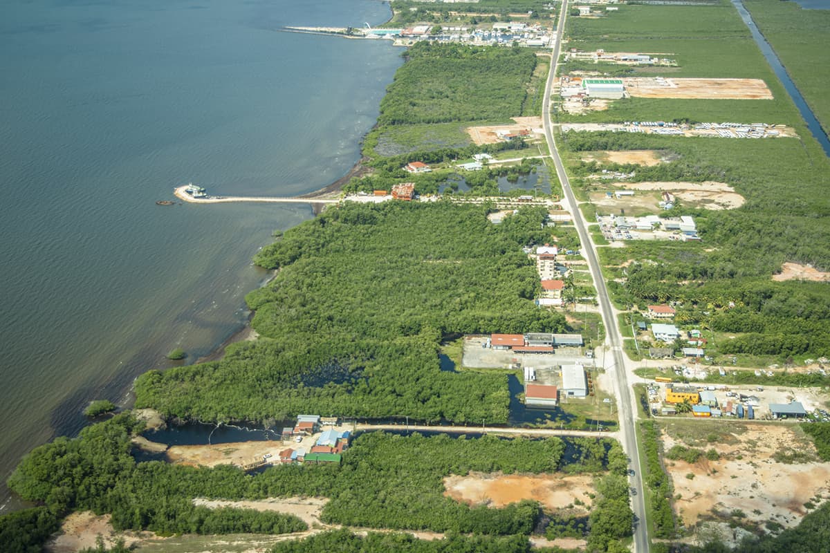 houses lined up along the coast as we go to land in belize