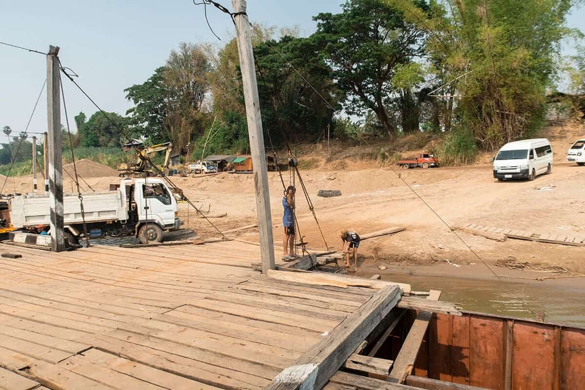 crossing the river connecting don det with mainland laos