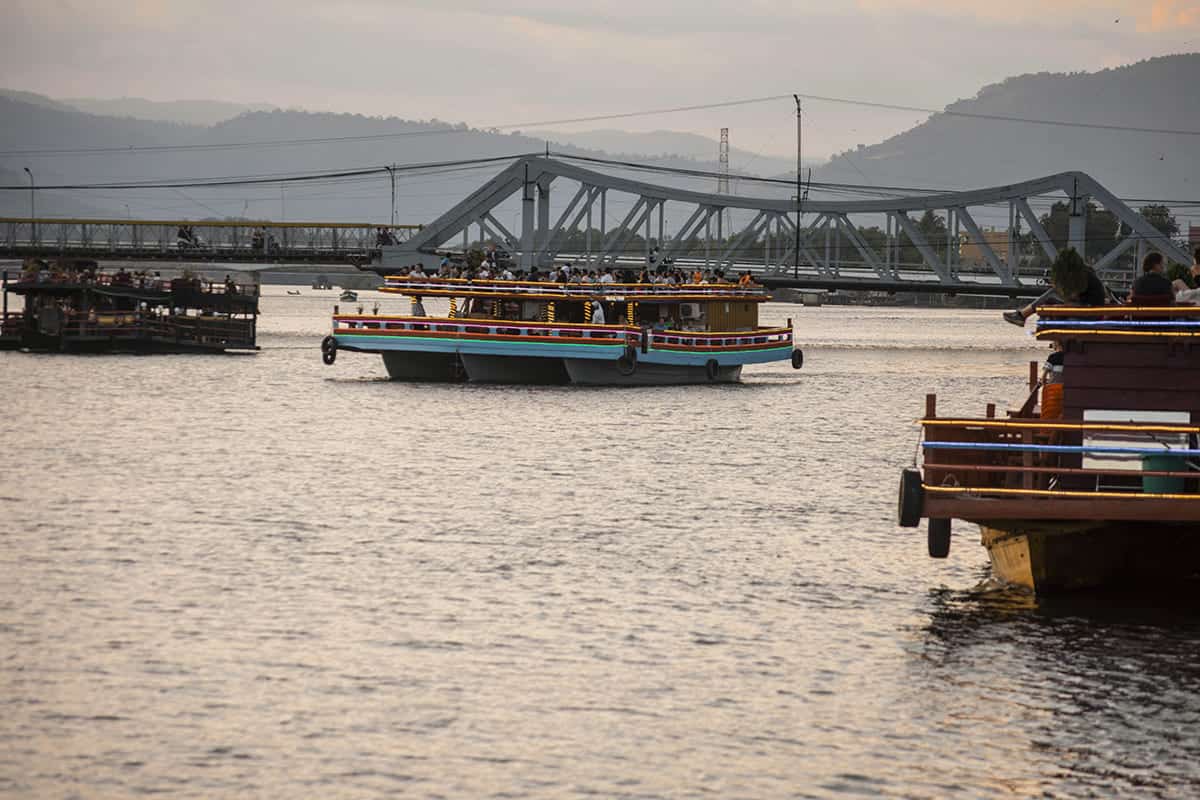 taking a boat in kampot along the river