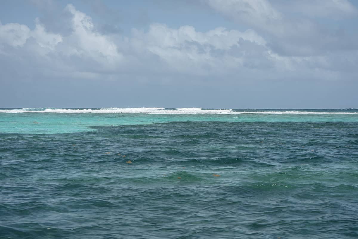 looking out to the waves crashing on the reef around ambergris caye
