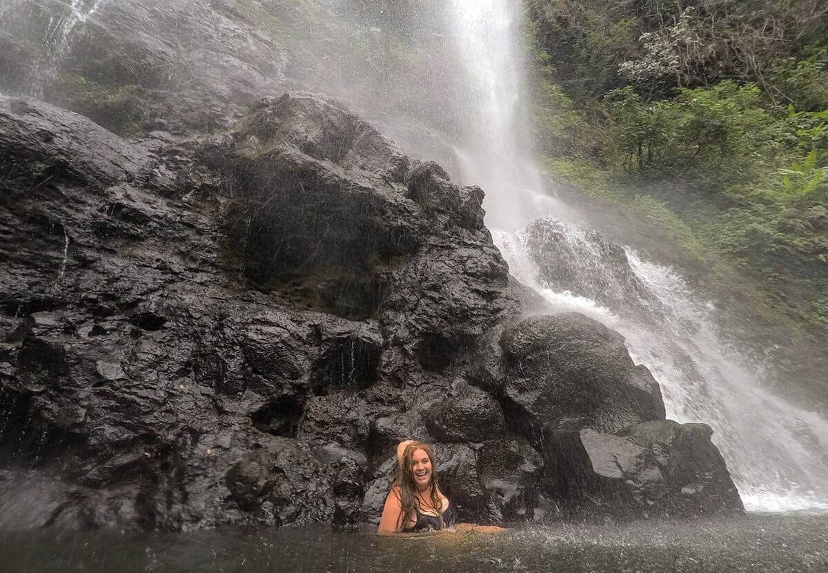 underneath the fall at tad yuang waterfall climbing on rocks