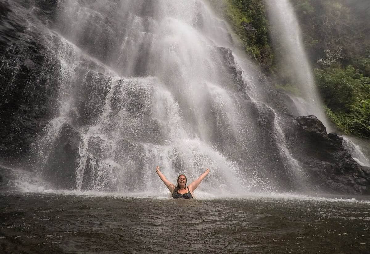 swimming underneath tad yuang waterfall