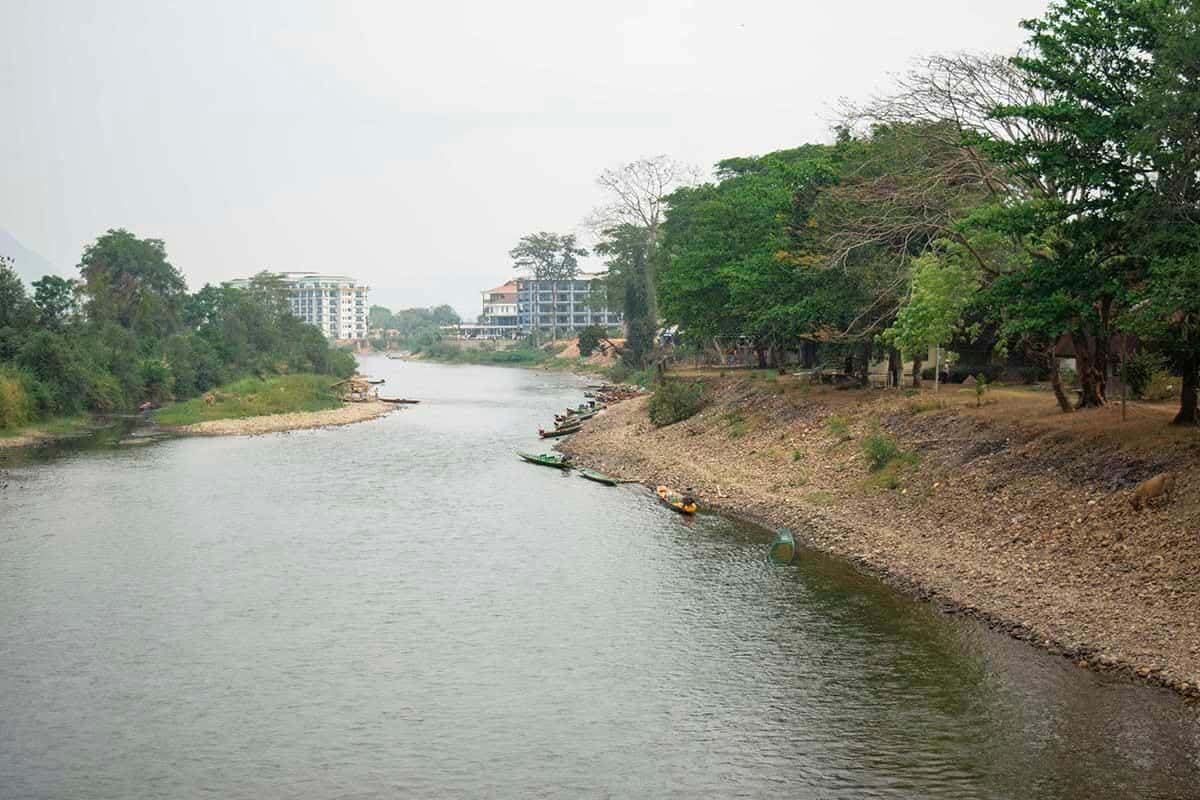 walking over a bridge above the nam song river in vang vieng