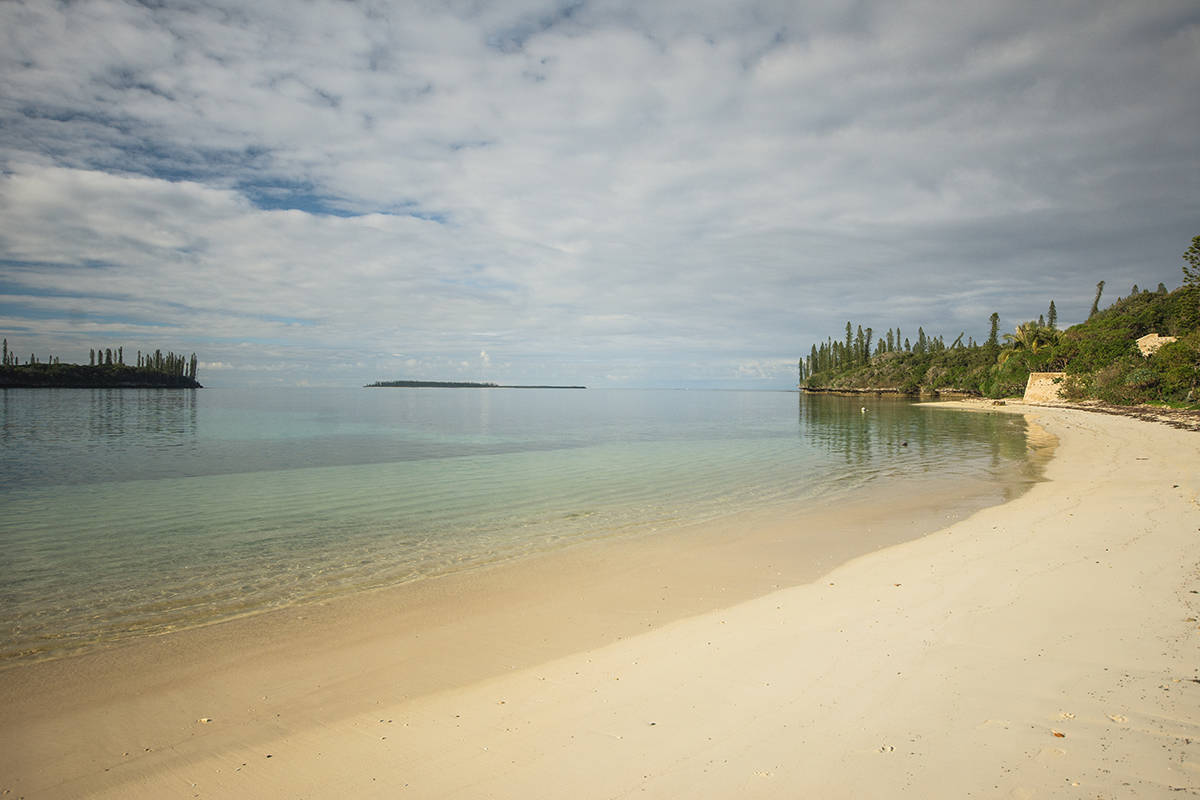 calm and clear waters at kanumera bay on isle of pines