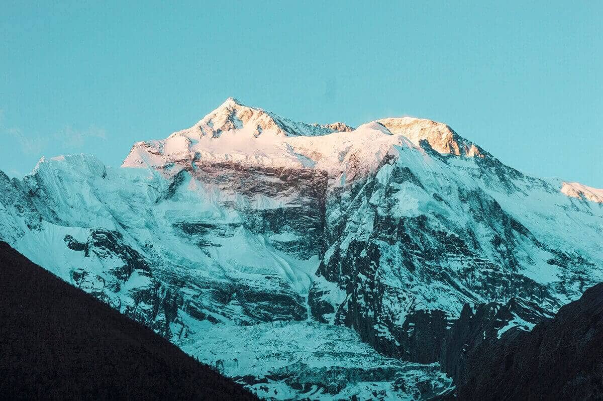 sun hitting mountain upper pisang to ngawal on the annapurna circuit nepal