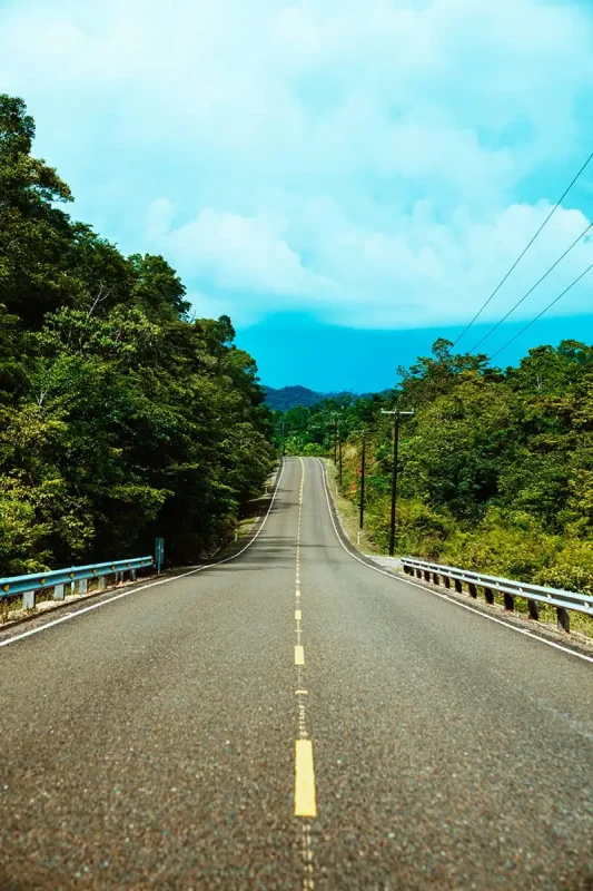 looking down one of the roads in belize connecting belize city with san ignacio