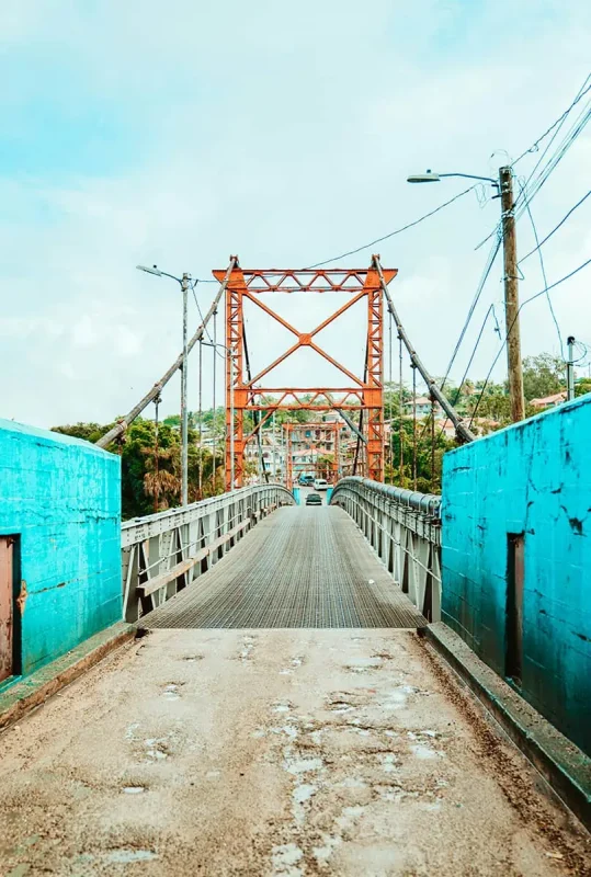 heading across the colorful main bridge in san ignacio leading to the town center