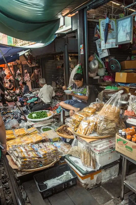 the stalls at the railway market in bangkok selling all sorts of goods