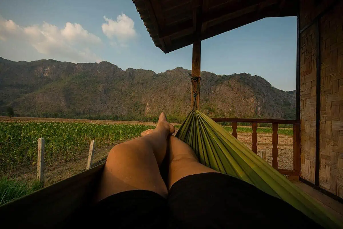 relaxing hammock and mountains in kong lor on the 2 weeks in laos itinerary