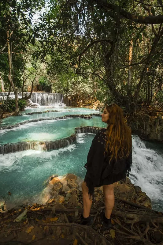 tasha amy standing infront of the lower pools at kuang si falls in luang prabang on the backpacking laos itinerary
