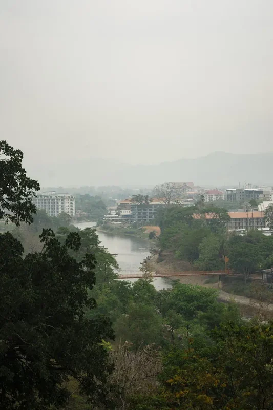 looking over the the township of vang vieng from a viewpoint in a cave