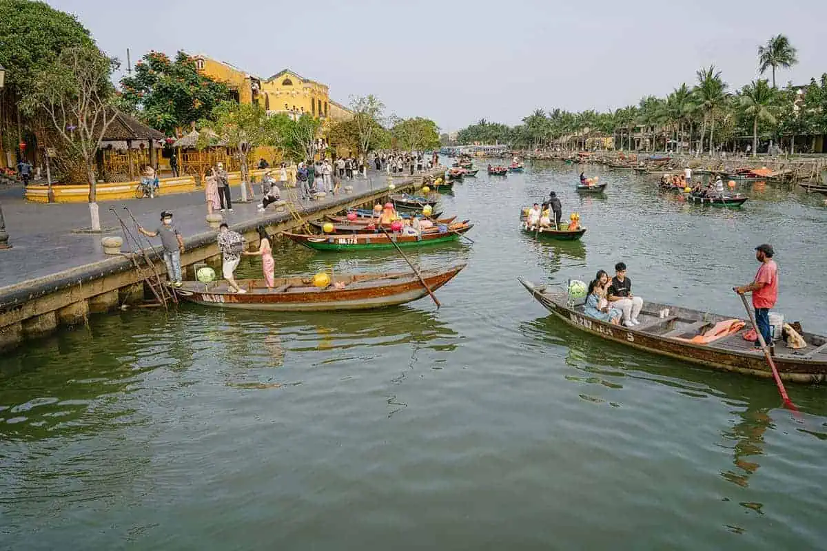 Bustling river scene with traditional boats and tourists in Hoi An, a vibrant part of any 3 week Vietnam itinerary.