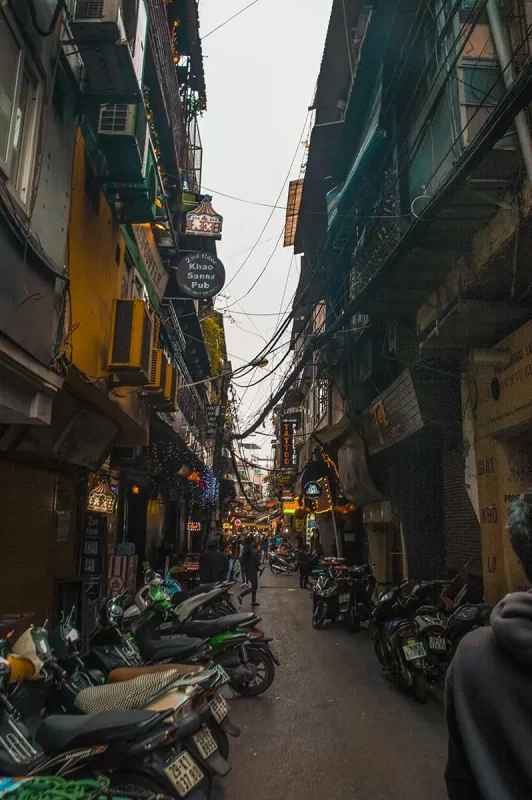 Narrow lane with many motorbikes parked up in Hanoi's Old Quarter