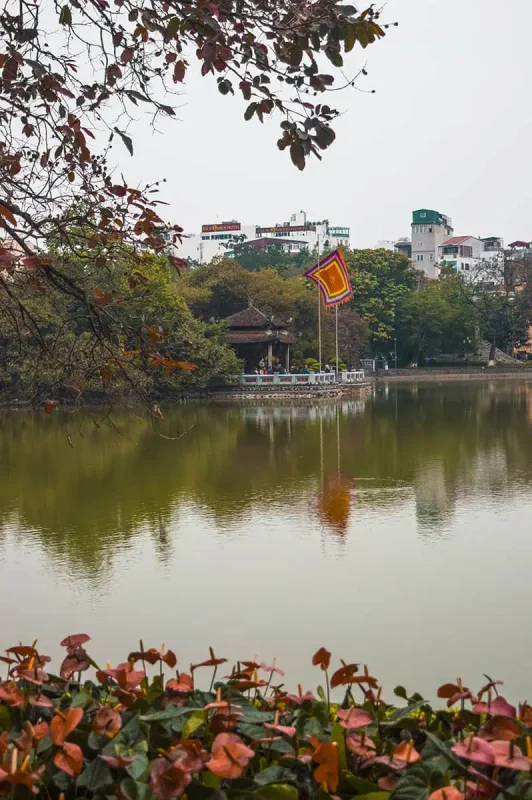 Tranquil Hoan Kiem Lake with a view of Turtle Tower, a peaceful retreat in a busy Vietnam itinerary
